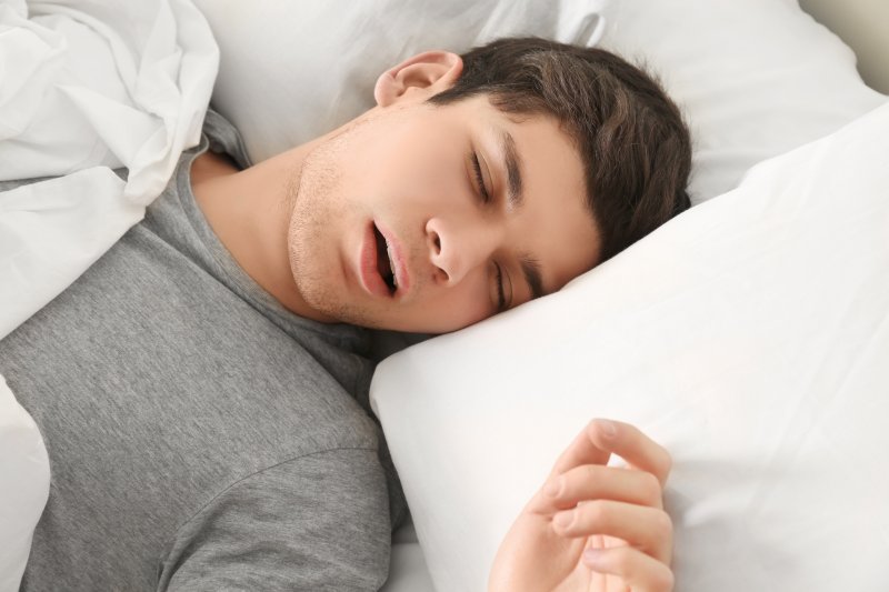 young man asleep while mouth breathing
