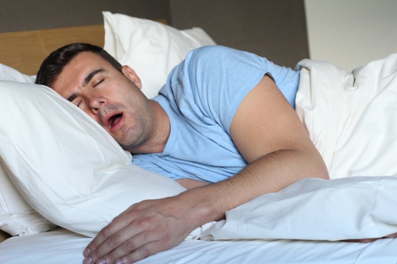 man asleep and drooling in bed